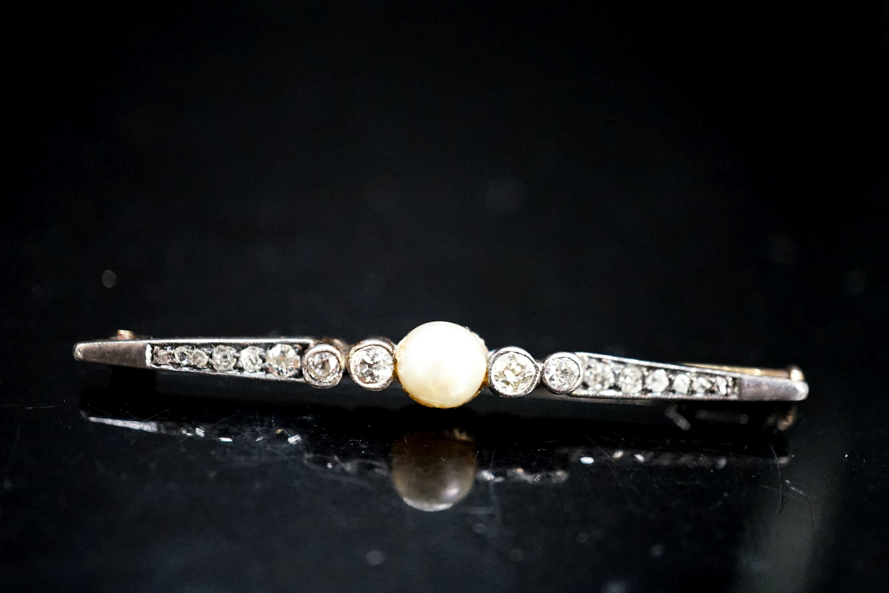 An early 20th century pearl and diamond set bar brooch, 50mm, gross 3.8 grams.